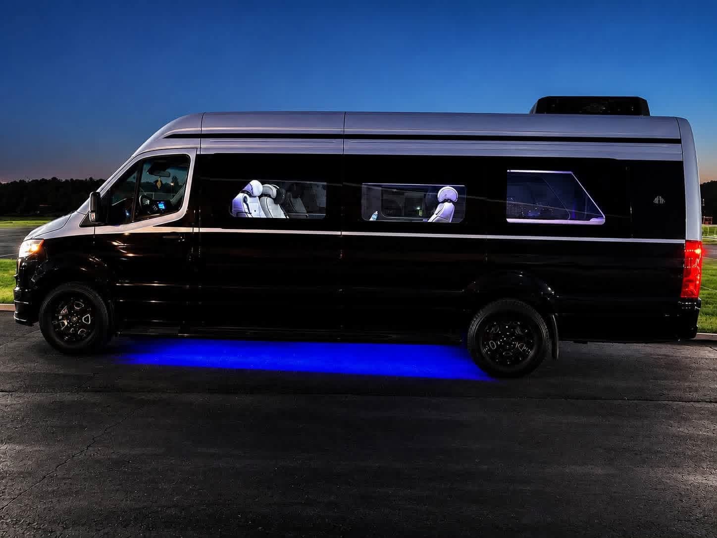 The Avalon Mercedes-Benz Sprinter limousine at dusk — Excalibur black car service in Edmond, Oklahoma